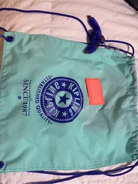 Kipling Aqua Drawstring Bag with Purple Logo Accent